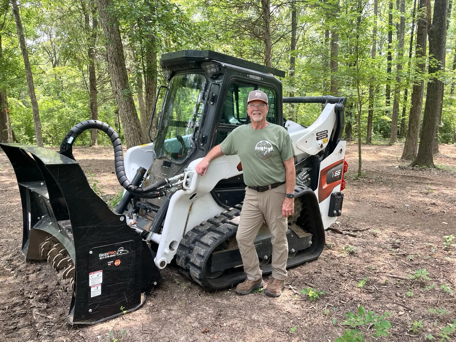 Owner with the tracked skid steer and forestry mulching head in Southern Illinois timber